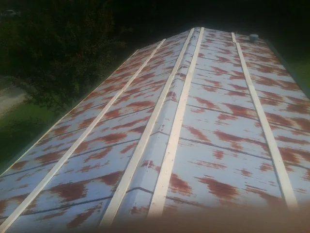 Rusted metal roof panels with new wood purlins before replacement — Storm Damage Roof Repair in Loomis by Roofing Brothers
