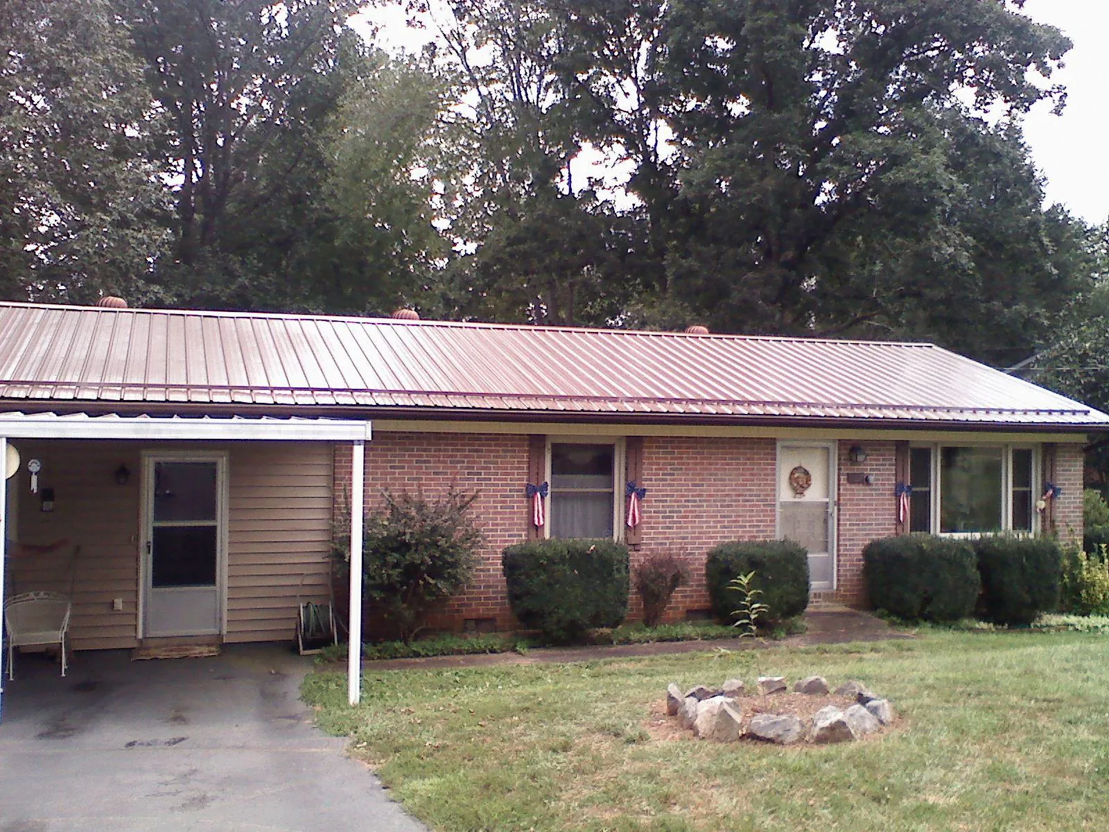 Bronze metal roof and carport on a brick ranch home — Roof Repair work by our crew in Loomis