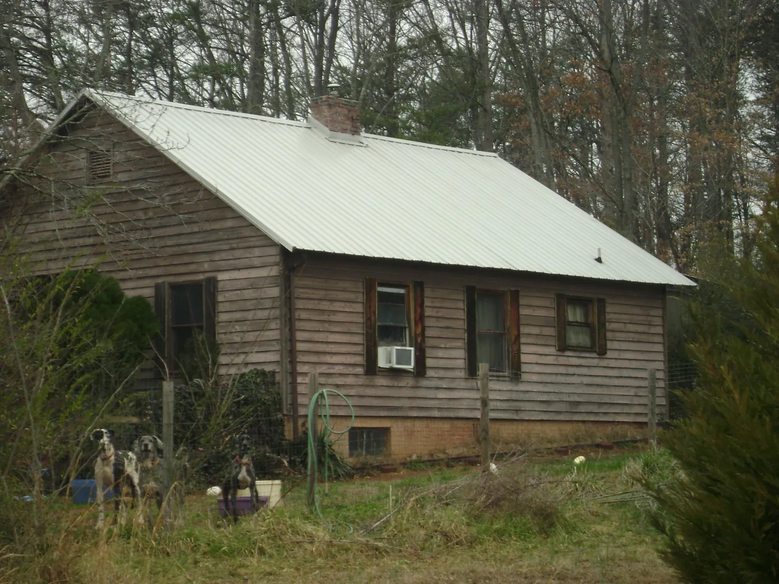 White metal roof on an old wood sided farmhouse, from a Metal Roof Installation job in Loomis